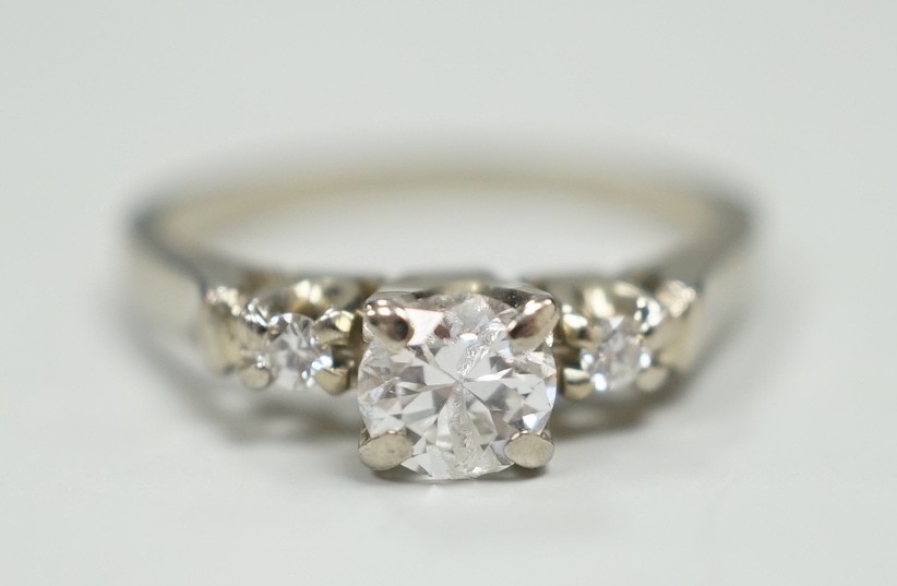 A Canadian Birks 18k white metal and single stone diamond ring, with diamond set shoulders, size H, gross weight 2.7 grams